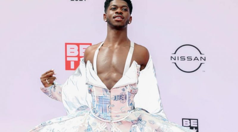 Lil Nas X poses for a photograph at the BET Awards in a flowing dress