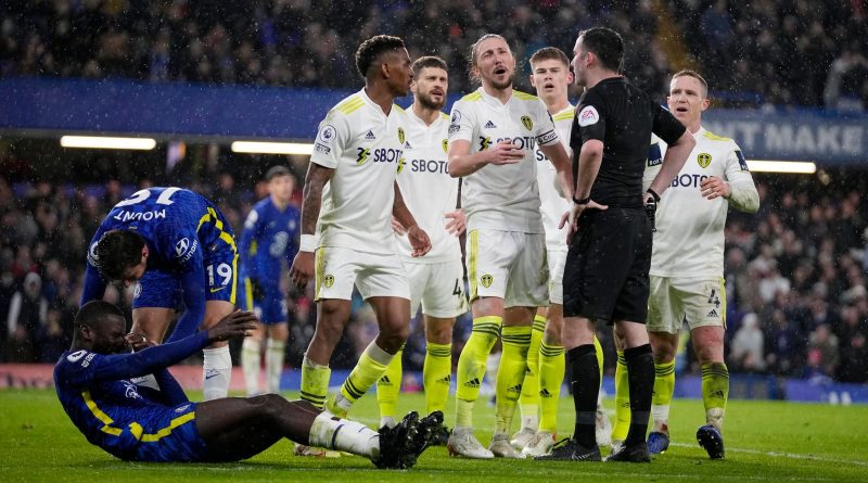 Chelsea's Antonio Rudiger lies on the ground as Leeds United players argue with referee Chris Kavanagh during the Premier League match between Chelsea and Leeds United at Stamford Bridge on Dec.11, 2021. (AP Photo/Matt Dunham)