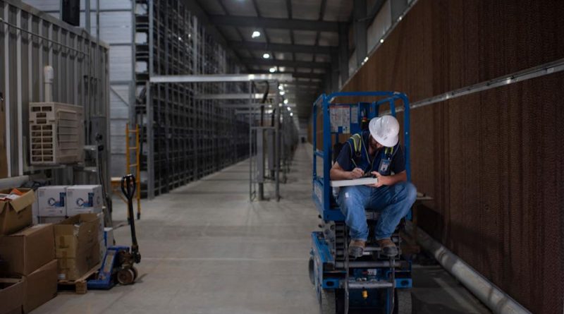 A worker fills out a form at the Whinstone US Bitcoin mining facility in Rockdale, Texas, on October 10, 2021. - The long sheds at North America's largest bitcoin mine look endless in the Texas sun, packed with the type of machines that have helped the US to become the new global hub for the digital currency. The operation in the quiet town of Rockdale was part of an already bustling US business -- now boosted by Beijing's intensified crypto crackdown that has pushed the industry west. Experts say rule of law and cheap electricity in the US are a draw for bitcoin miners, whose energy-gulping computers race to unlock units of the currency.
