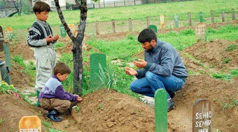 A Muslim man offers prayers at his son’s grave in Vitez, in current day Bosnia and Herzegovina.