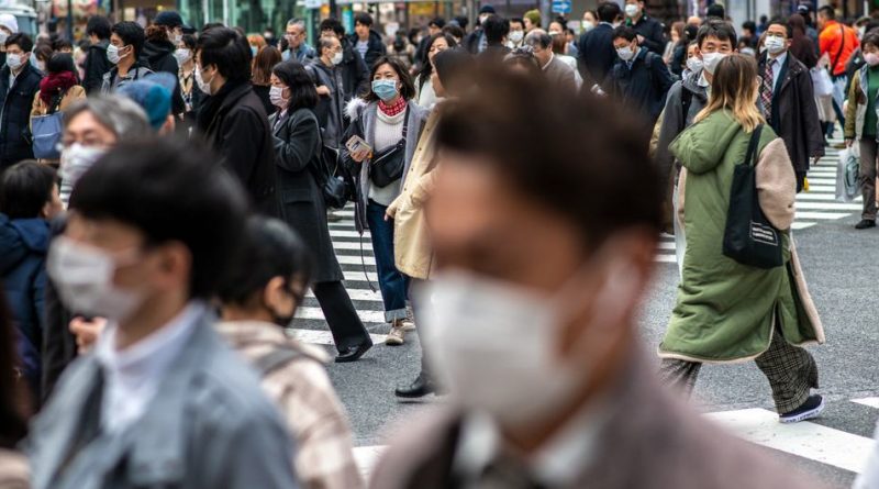 People wear protective masks in Tokyo, Japan.