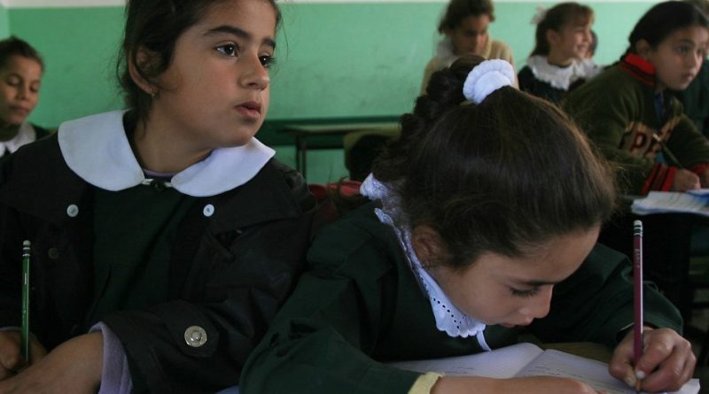 Girls work at a shared desk during a lesson at Omar Ben al-Khattab School in the town of Beit Lahia, in the northern Gaza Strip.  (file)