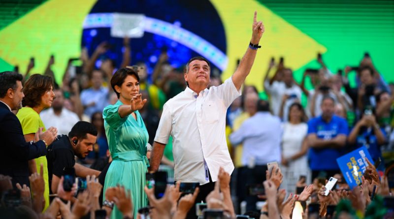 Jair Bolsonaro, Brazil's President, center, and first lady Michelle Bolsonaro attend the National Convention to formalize his candidacy for a second term, at Maracanazinho Gymnasium in Rio de Janeiro, on Sunday, July 24, 2022. (Andre Borges/Bloomberg via Getty Images)