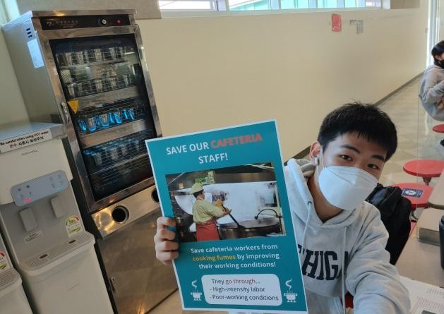 Soo Hyoun Lim's classmate doing a campaign inside the Yongsan International School’s cafeteria with the poster.