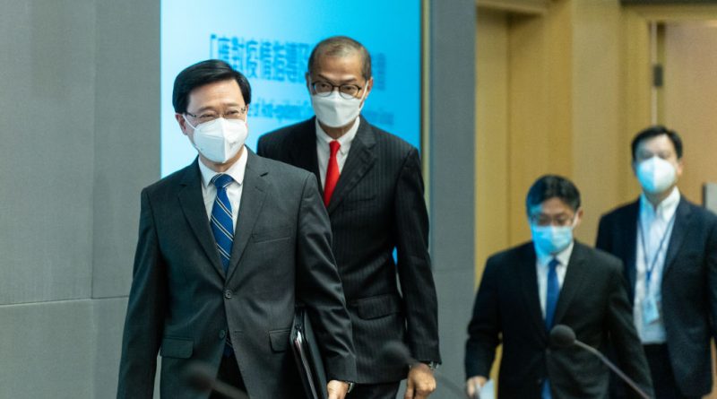 John Lee, Hong Kong's chief executive, left, and other officials arrive at a news conference to announce the end of hotel quarantine in Hong Kong, China, on Friday, Sept. 23, 2022. (Chan Long Hei/Bloomberg via Getty Images)