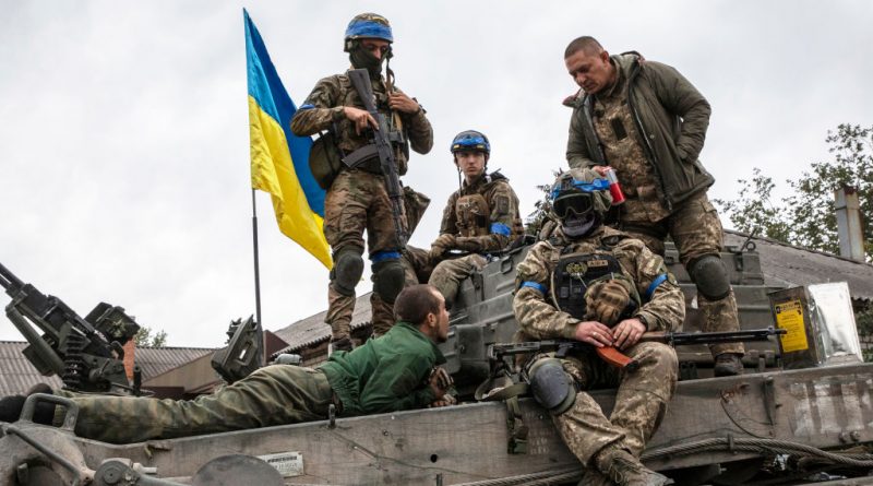 A Russian soldier, taken prisoner, on a tank with Ukrainian soldiers after the city of Izyum was recaptured from Russian forces on Sept 11, 2022 in Ukraine. (Laurent Van der Stockt for Le Monde/Getty Images)