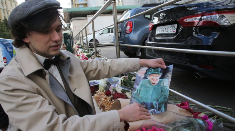 A mourner holds a portrait of Queen Elizabeth II near the wall of the Embassy of the United Kingdom at Lugansk People's Republic Square, September 9, 2022, in Moscow, Russia. Russian President Vladimir Putin has no plans to fly to Elizabeth II's funeral, a Kremlin spokesman said (Contributor/Getty Images)