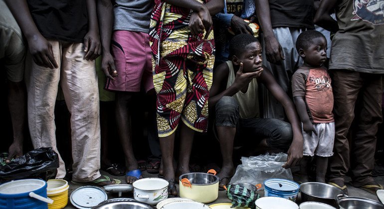 Internally displaced Congolese families from Kasai Province wait in line for food in the grounds of a former clinic in the town of Idiofa, Kwilu Province after fleeing violence near their villages.