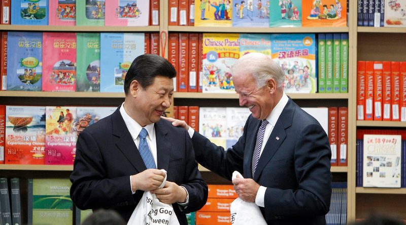 Xi Jinping and U.S. Vice President Biden hold T-shirts students gave them at the International Studies Learning Center in South Gate, California, on Feb. 17 2012. (Damian Dovarganes—AP Chinese Vice-President)