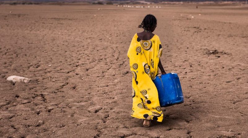 A girl walks with a water container in the Afar region in Ethiopia.