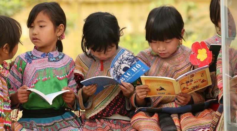 Girls from an indigenous community read outdoors at Ban Pho Primary School in Bac Han District in remote Lao Cai Province, Viet Nam.