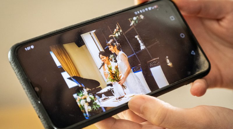 Miki showing a picture of her wedding with her partner Katie at their home in Tokyo, Oct 30. Tokyo began issuing partnership certificates to same-sex couples who live and work in the capital on Nov. 1, a long-awaited move in a country without marriage equality. (Yuichi Yamazaki—AFP/Getty Images)