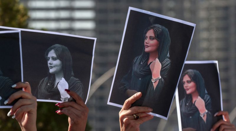 Women hold up signs depicting the image of 22-year-old Mahsa Amini, who died while in the custody of Iranian authorities, during a demonstration denouncing her death by Iraqi and Iranian Kurds outside the U.N. offices in Erbil, the capital of Iraq's autonomous Kurdistan region, on Sept. 24, 2022. Safin Hamed—AFP/Getty Images (AFP via Getty Images)