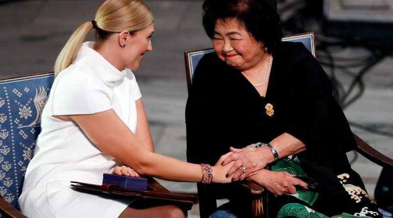Hiroshima nuclear bombing survivor Setsuko Thurlow touches the hand of Beatrice Fihn, left, during the award ceremony of the 2017 Nobel Peace Prize at the city hall in Oslo, Norway, on Dec. 10, 2017. (Odd Andersen—AFP/Getty Images)