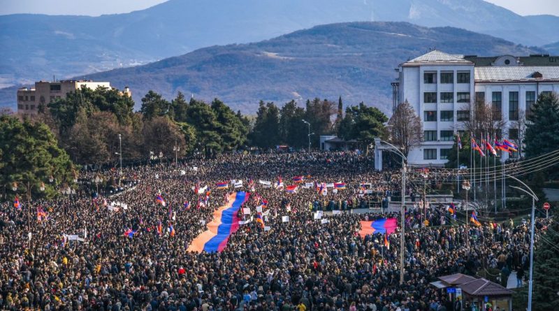 Protesters hold a giant Armenian flag as they attend a rally in Stepanakert, Nagorno-Karabakh on Dec. 25, 2022. (Davit Ghahramanya—AFP via Getty Images)