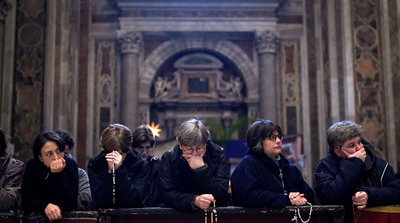 People pray as Pope Emeritus Benedict XVI lies in state at St. Peter’s Basilica on Jan. 3, 2023, in Vatican City. (Christopher Furlong—Getty Images)